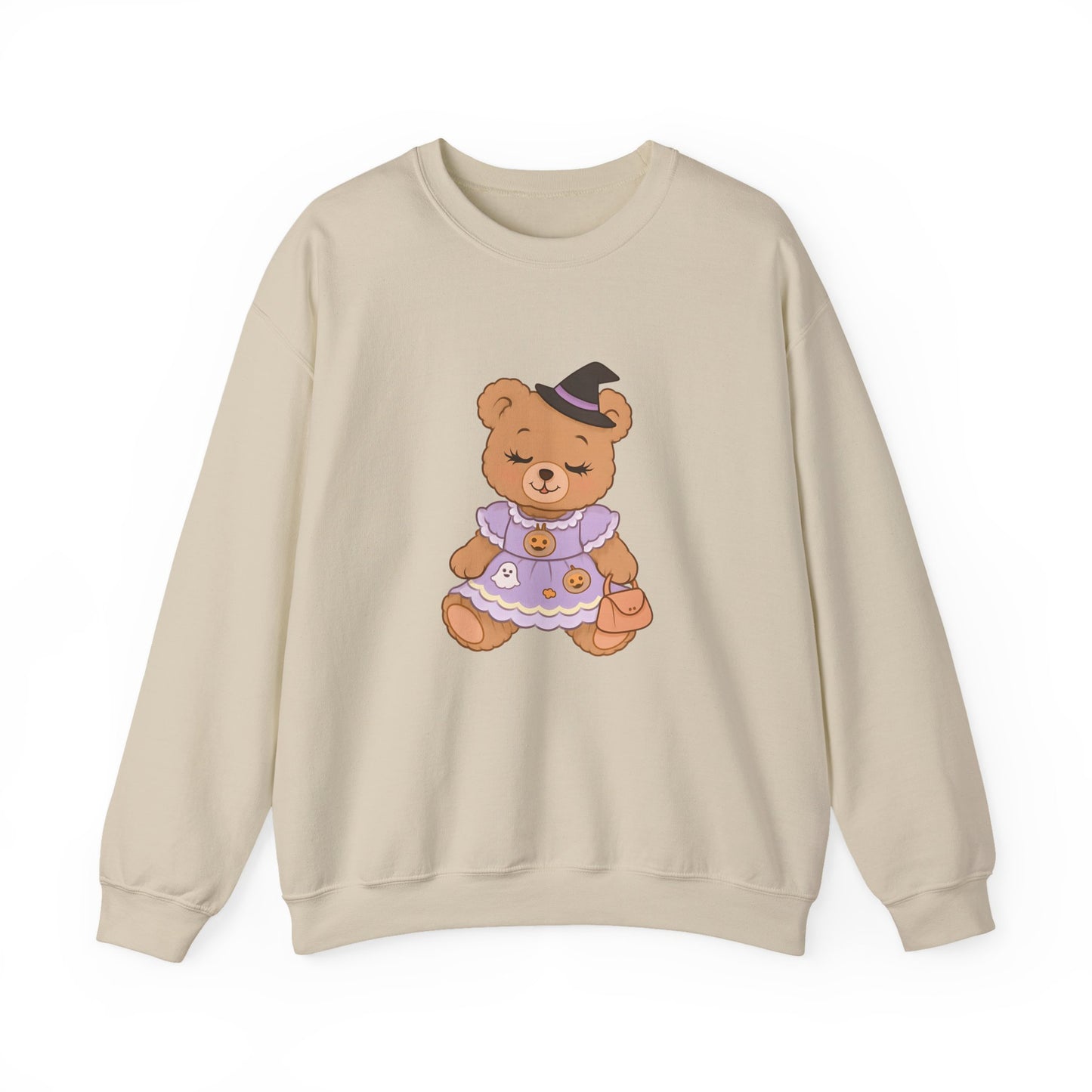 Beige sweatshirt with a teddy bear design wearing a witch hat and purple dress on a white background
