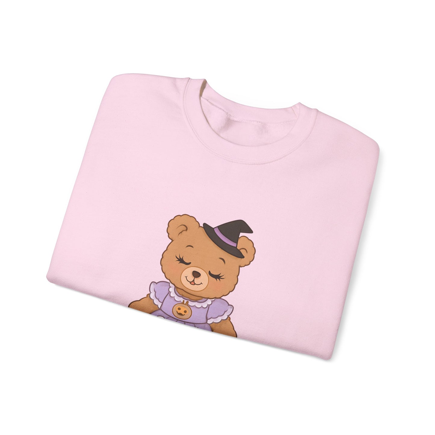 Folded pink sweatshirt with a teddy bear graphic on a white background