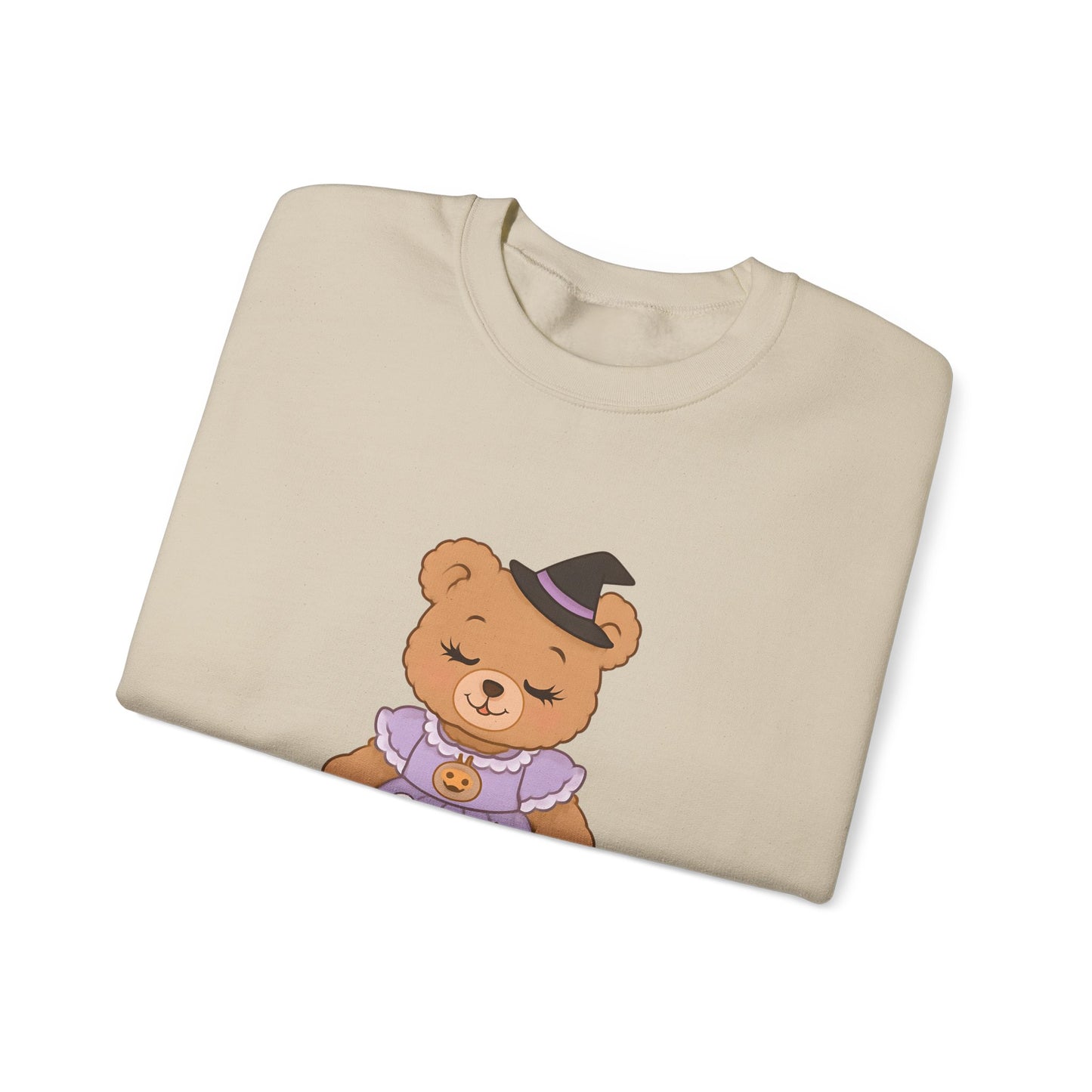 Folded beige sweatshirt with a teddy bear graphic on a white background