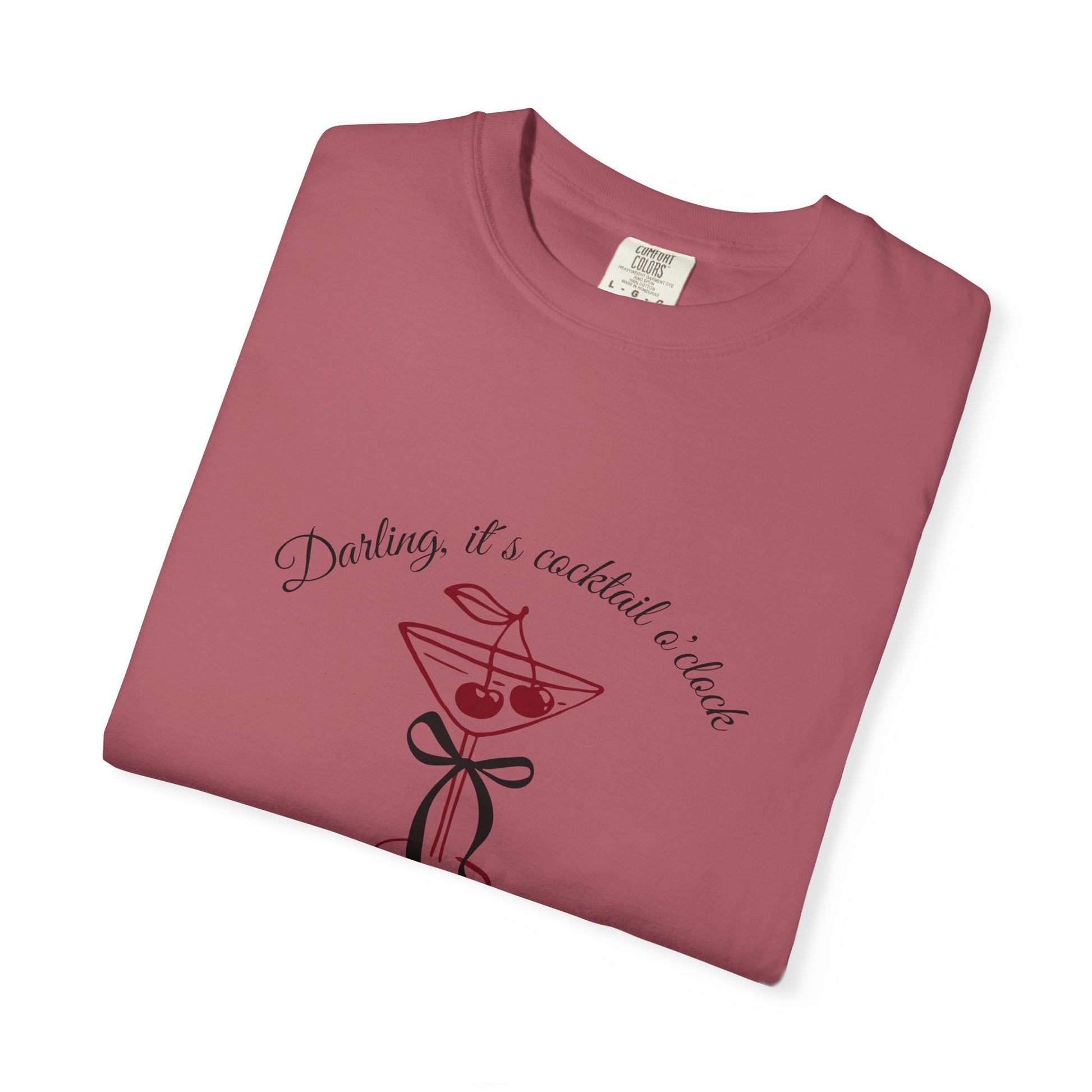 Folded maroon t-shirt with cocktail graphic and text on a white background