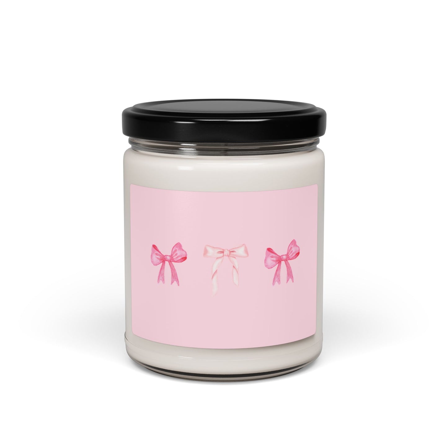 Candle jar with a pink label featuring three bows on a white background