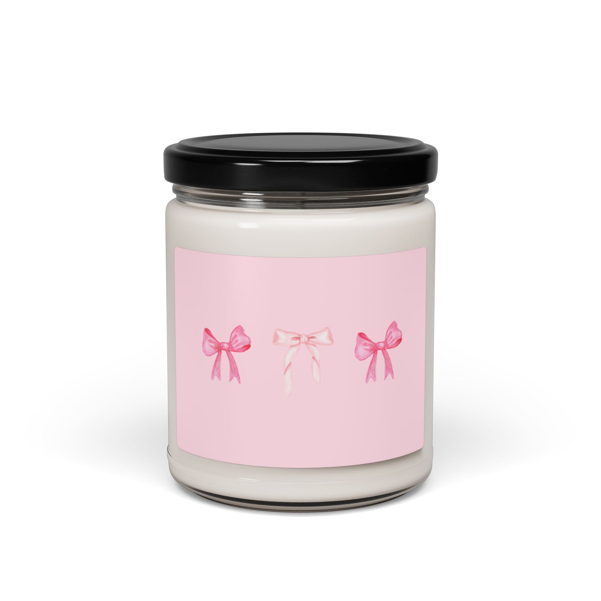 Candle jar with a pink label featuring three bows on a white background