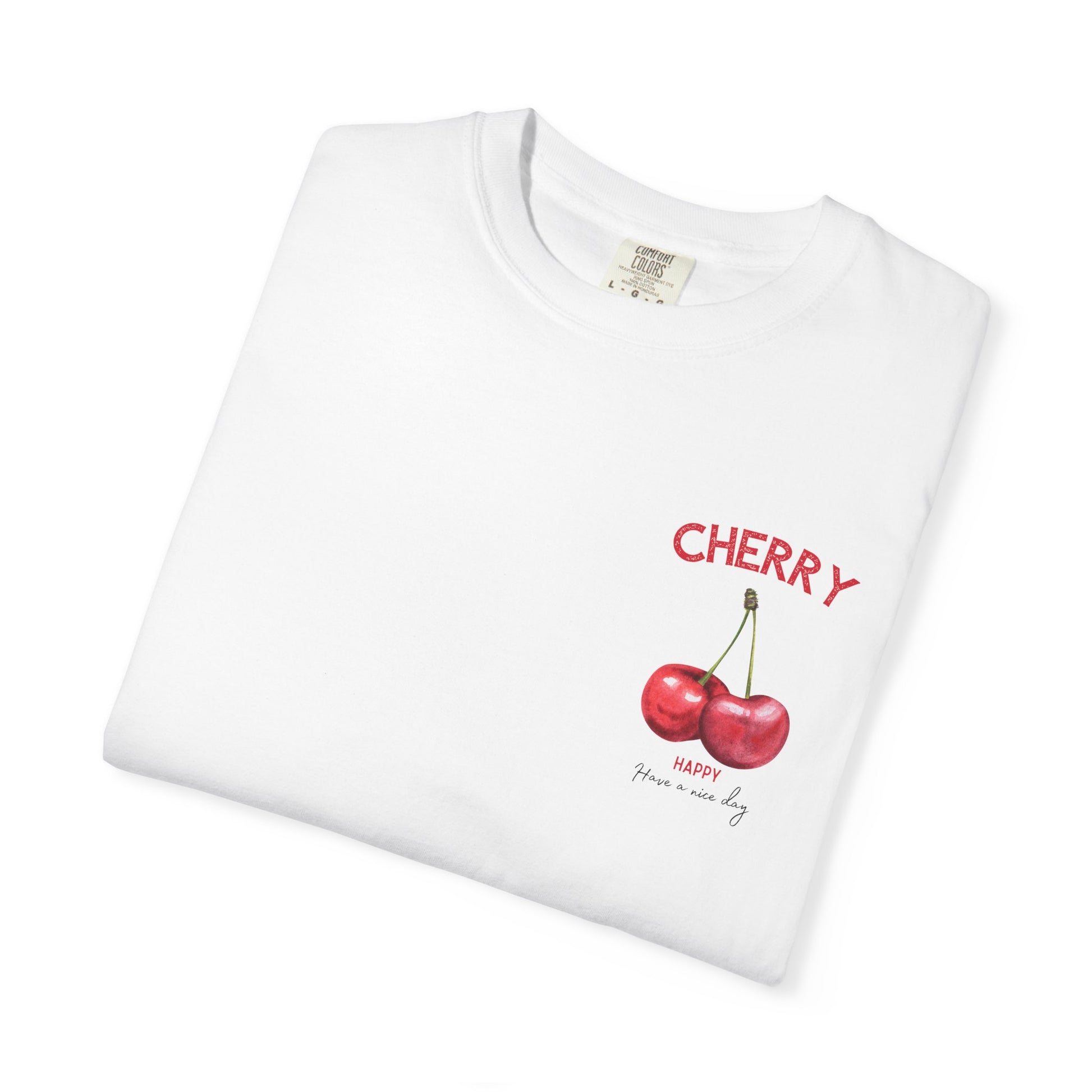 Folded white t-shirt with cherry fruit graphic design on the chest, cute summer outfit style.
