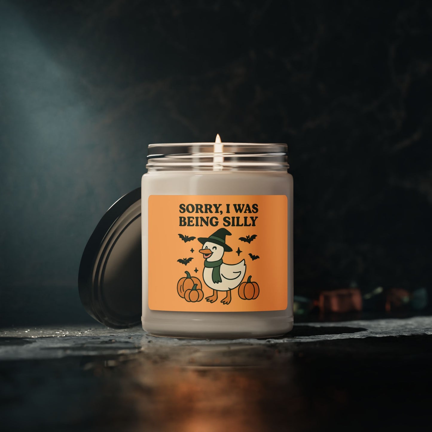 Candle with a Halloween-themed label on a dark background