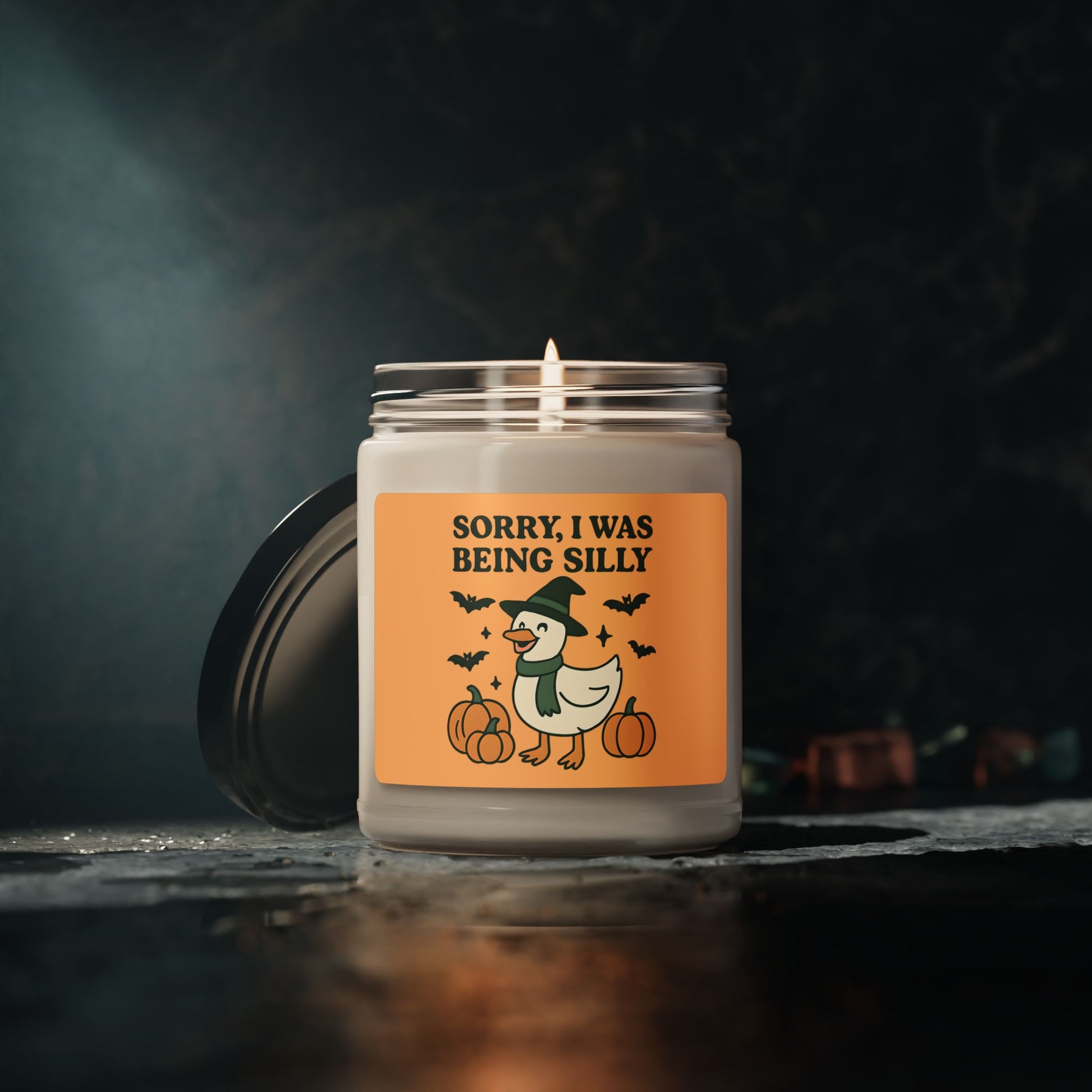 Candle with a Halloween-themed label on a dark background